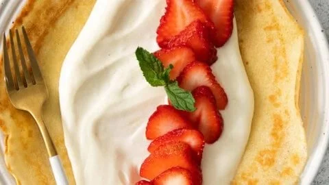 Delicious cream cheese crepe filling spread on a homemade crepe