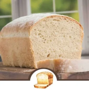 Freshly baked farmhouse sourdough loaf on a wooden table.