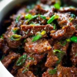 Delicious Slow Cooker Mongolian Beef served in a bowl with fresh green onions
