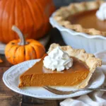 Foolproof homemade pumpkin pie served on a festive Thanksgiving table